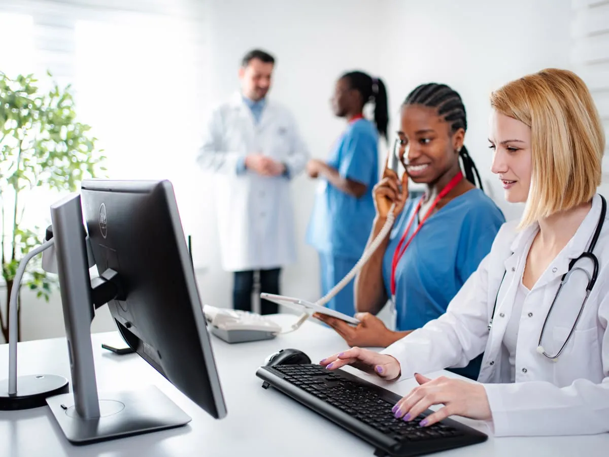 A healthcare team reviewing patient administration systems