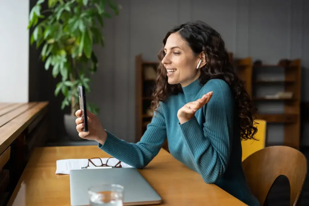 smiling female sit at office desk talk via videoca 2025 03 08 23 40 02 utc