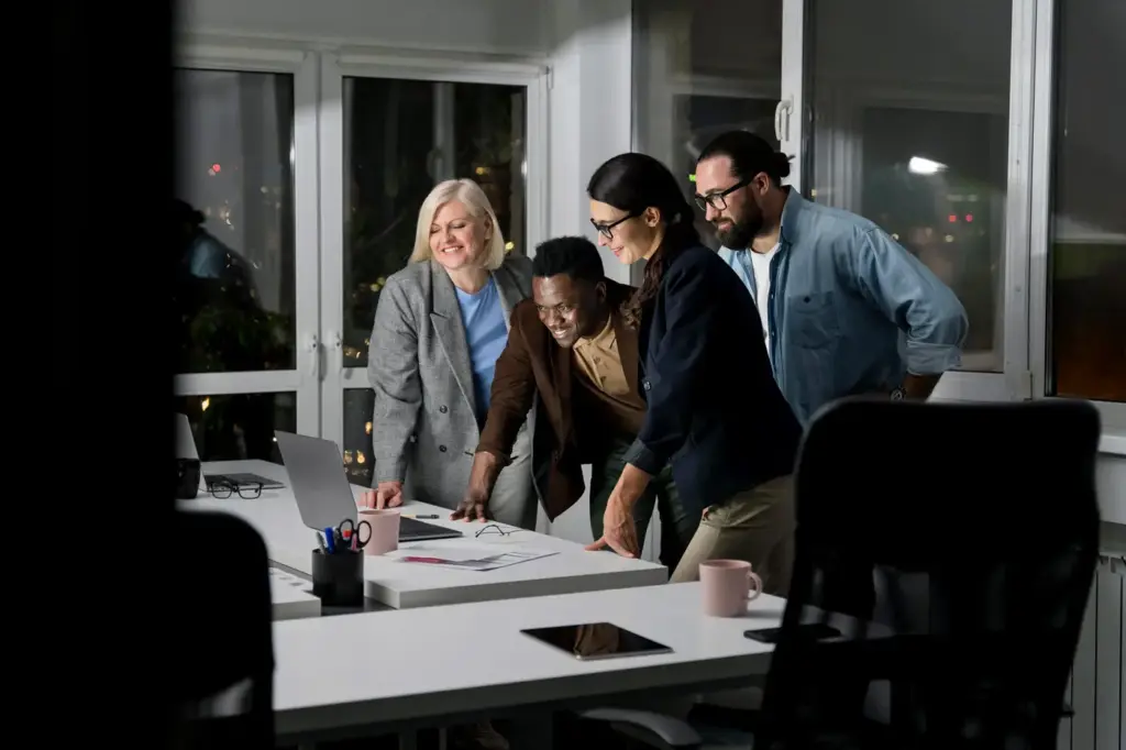 teammates working late office